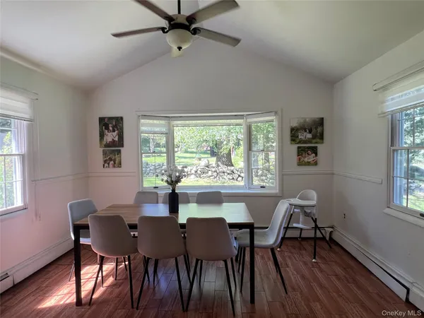 a view of a dining room with furniture window and wooden floor
