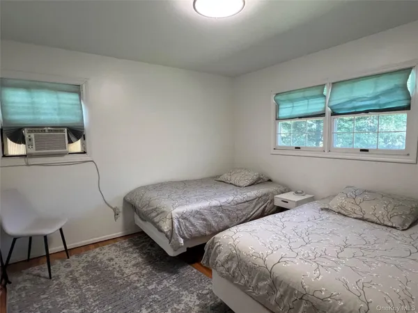 a bedroom with two beds and a window