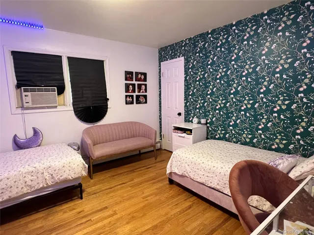 a bedroom with double bed and a couch