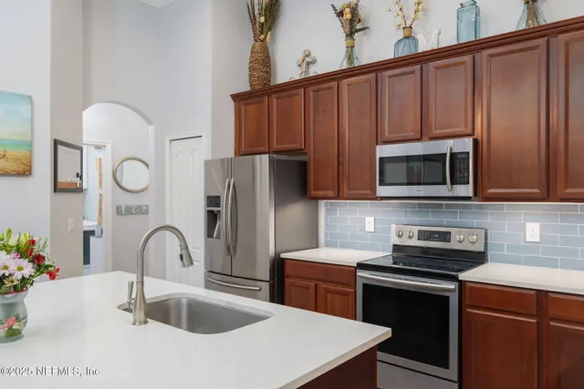 a spacious bedroom with a bed a couch and a bookshelf with wooden floor
