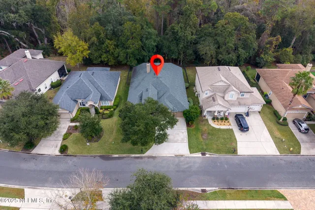 an aerial view of a house with a yard