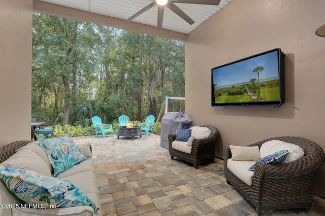 an aerial view of a house a yard swimming pool and outdoor seating