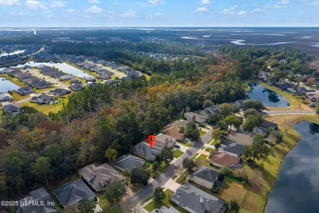an aerial view of residential houses with outdoor space and swimming pool