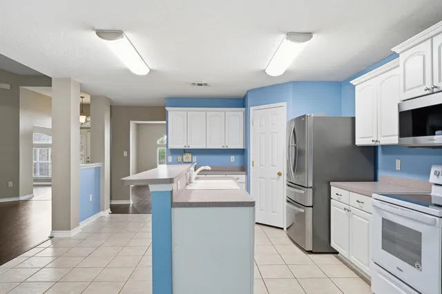 a kitchen with stainless steel appliances a sink stove and microwave