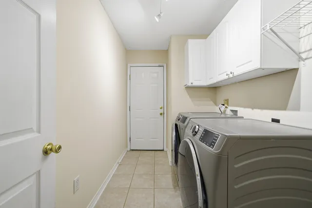 a spacious bathroom with a bathtub sink and mirror