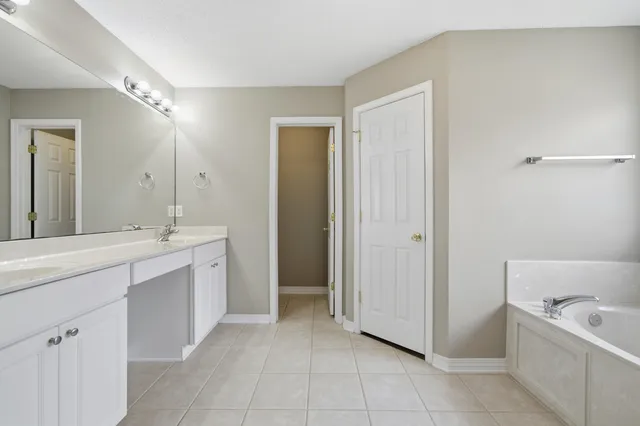a bathroom with a double vanity sink and a bathtub