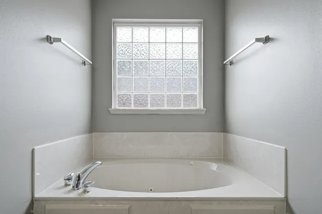 a view of a house with a big yard and large trees