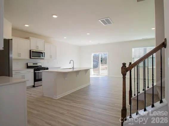 a kitchen with stainless steel appliances a refrigerator and a stove top oven