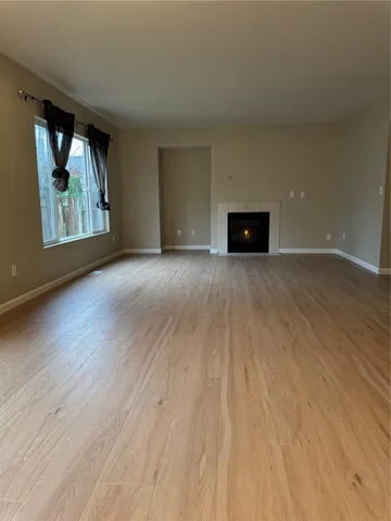 a view of an empty room and wooden floor