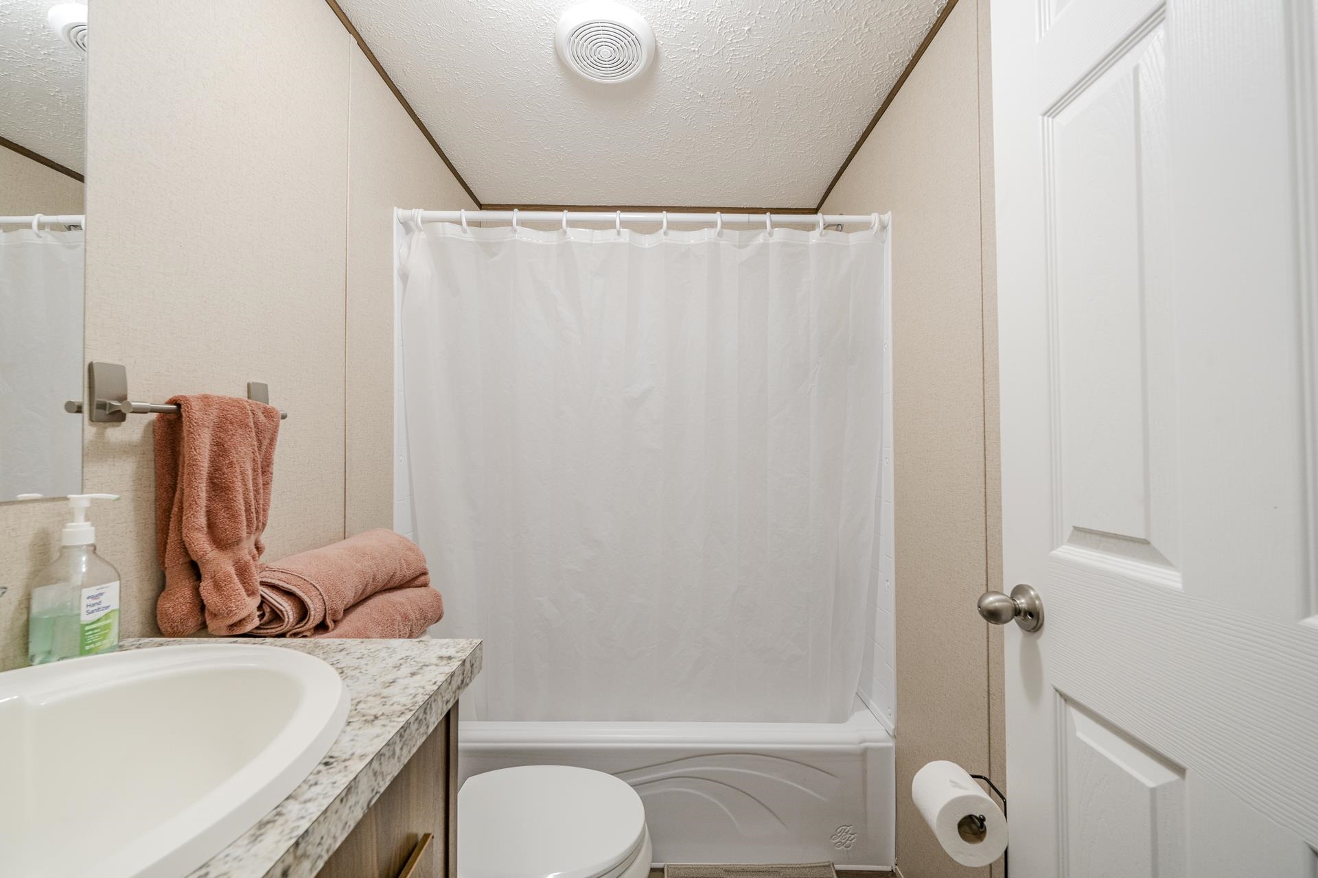 3275 Glendale Road Adamsville, TN 38310 - Photo 26 of 39 a bathroom with a granite countertop bathtub shower sink vanity and toilet