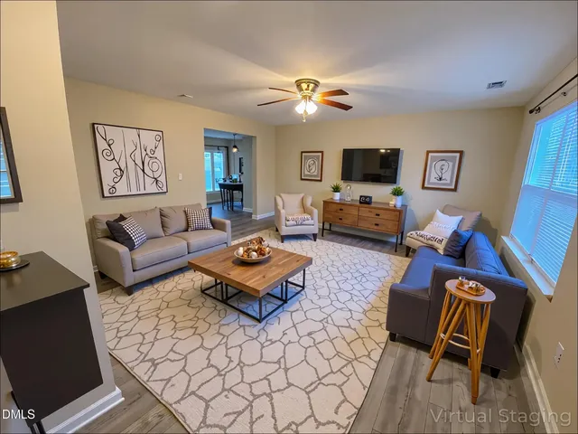 a living room with furniture and a flat screen tv