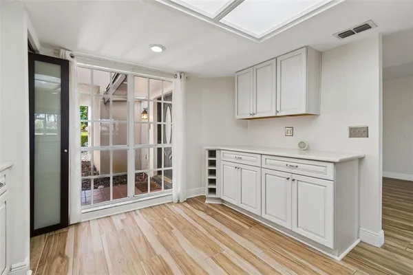 an empty room with wooden floor and fireplace