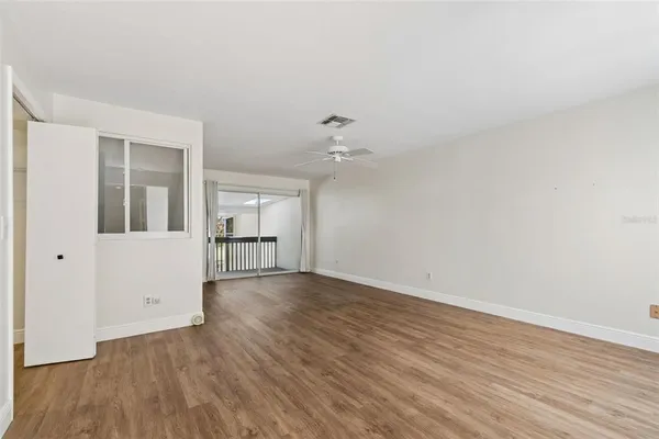 wooden floor in an empty room with a window
