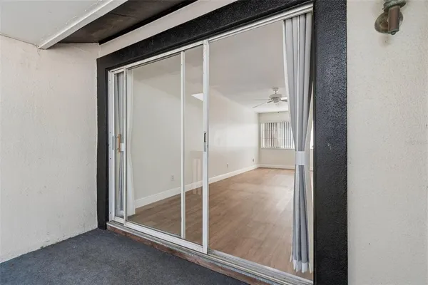 a view of a room with wooden floor