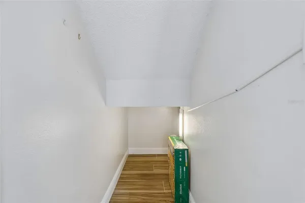 an empty room with wooden floor and mirror