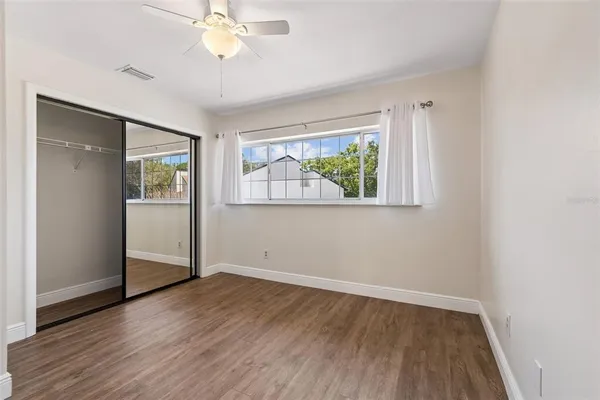 an aerial view of residential houses with outdoor space and trees