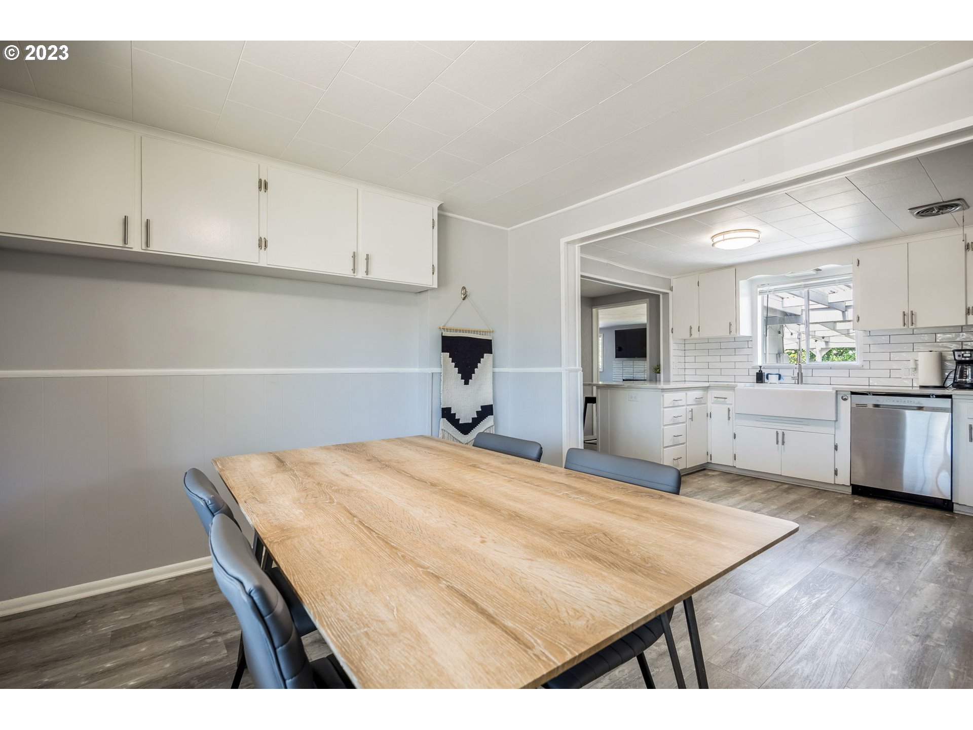 2290 E Street Springfield, OR 97477 - Photo 18 of 45 a kitchen with a wooden floor and white cabinets