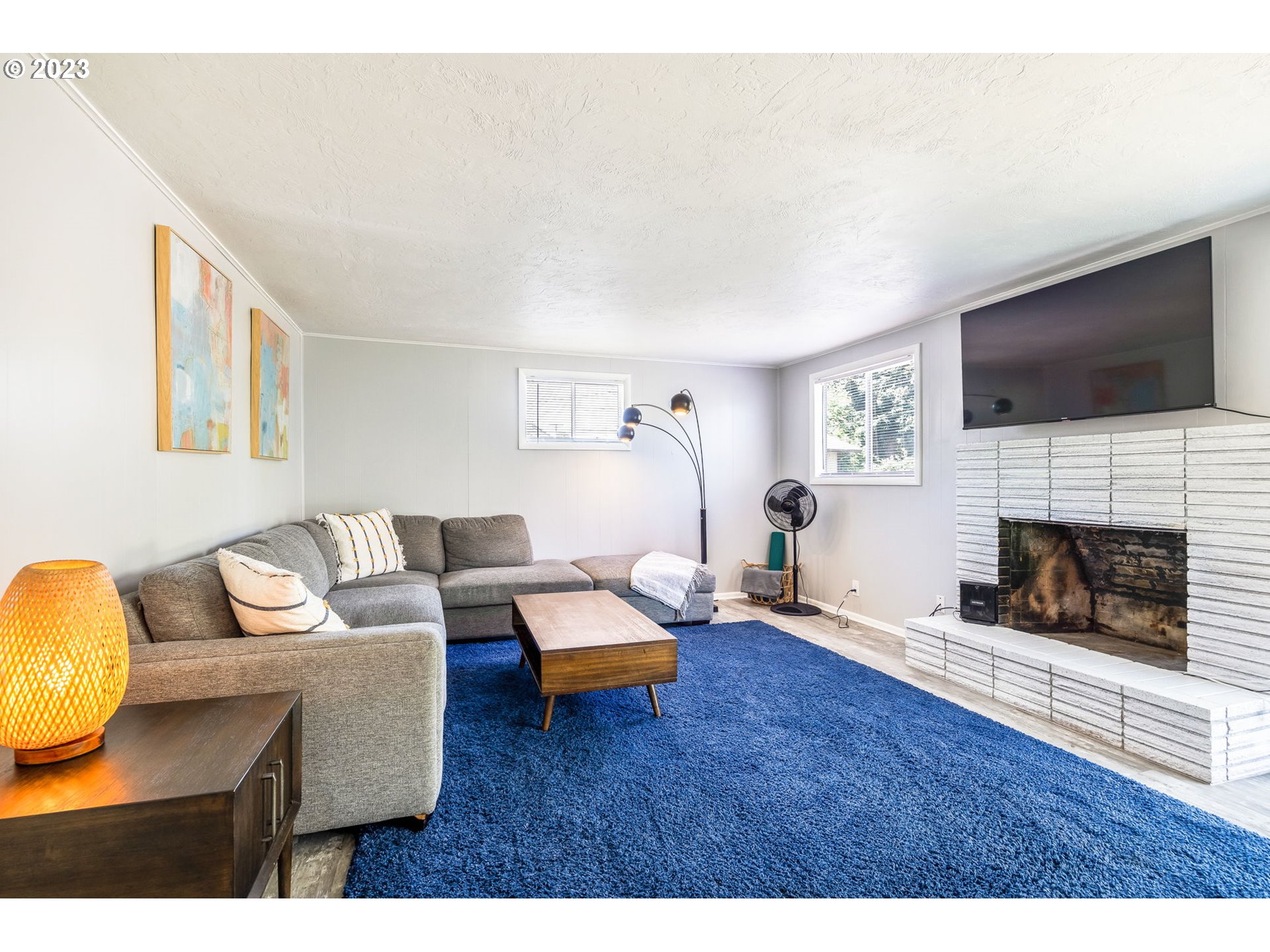 2290 E Street Springfield, OR 97477 - Photo 23 of 45 a living room with furniture a flat screen tv and a fireplace