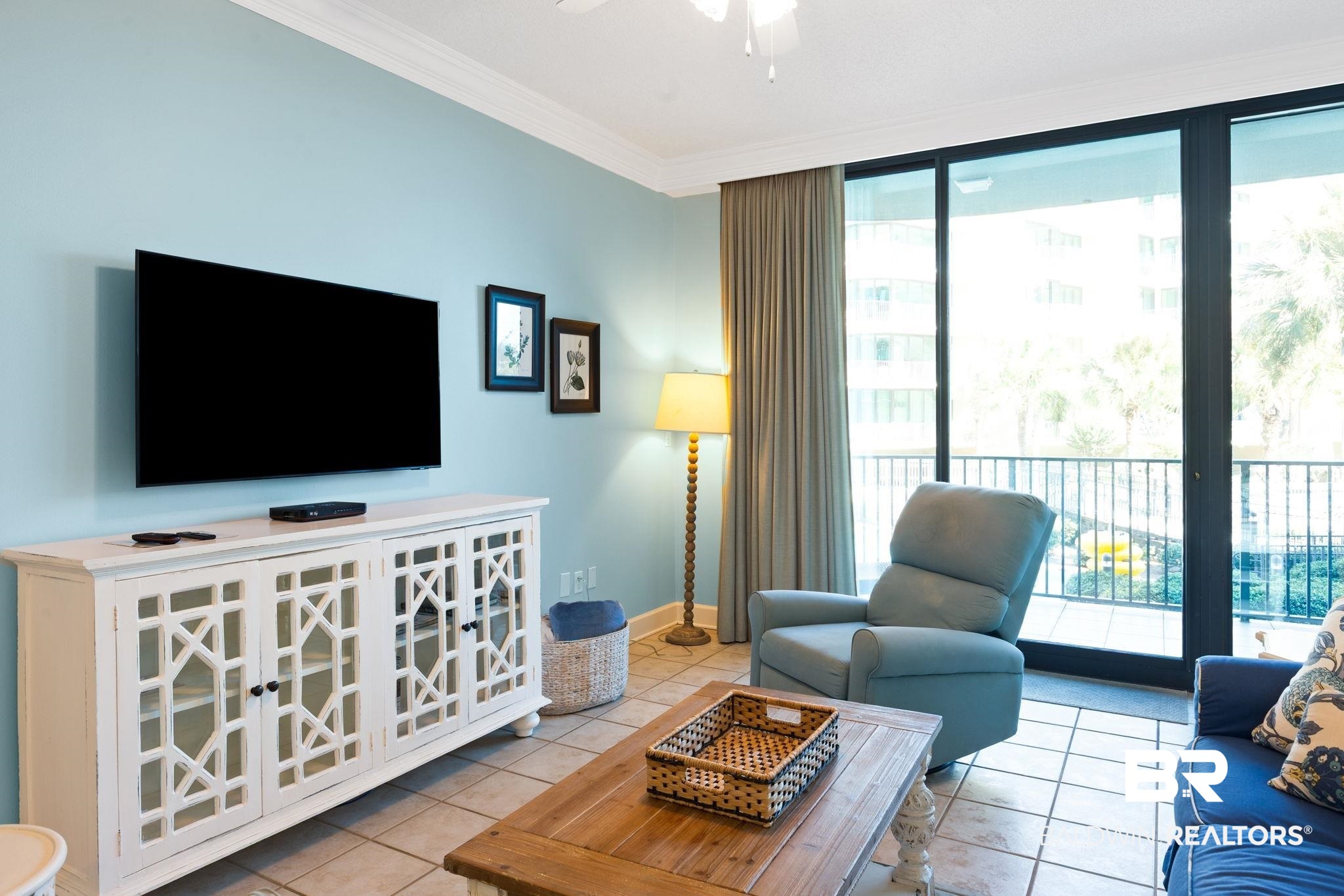 27580 Canal Road, Unit 1112 Orange Beach, AL 36561 - Photo 7 of 50 Living room featuring floor to ceiling windows, light tile patterned floors, ornamental molding, and a ceiling fan