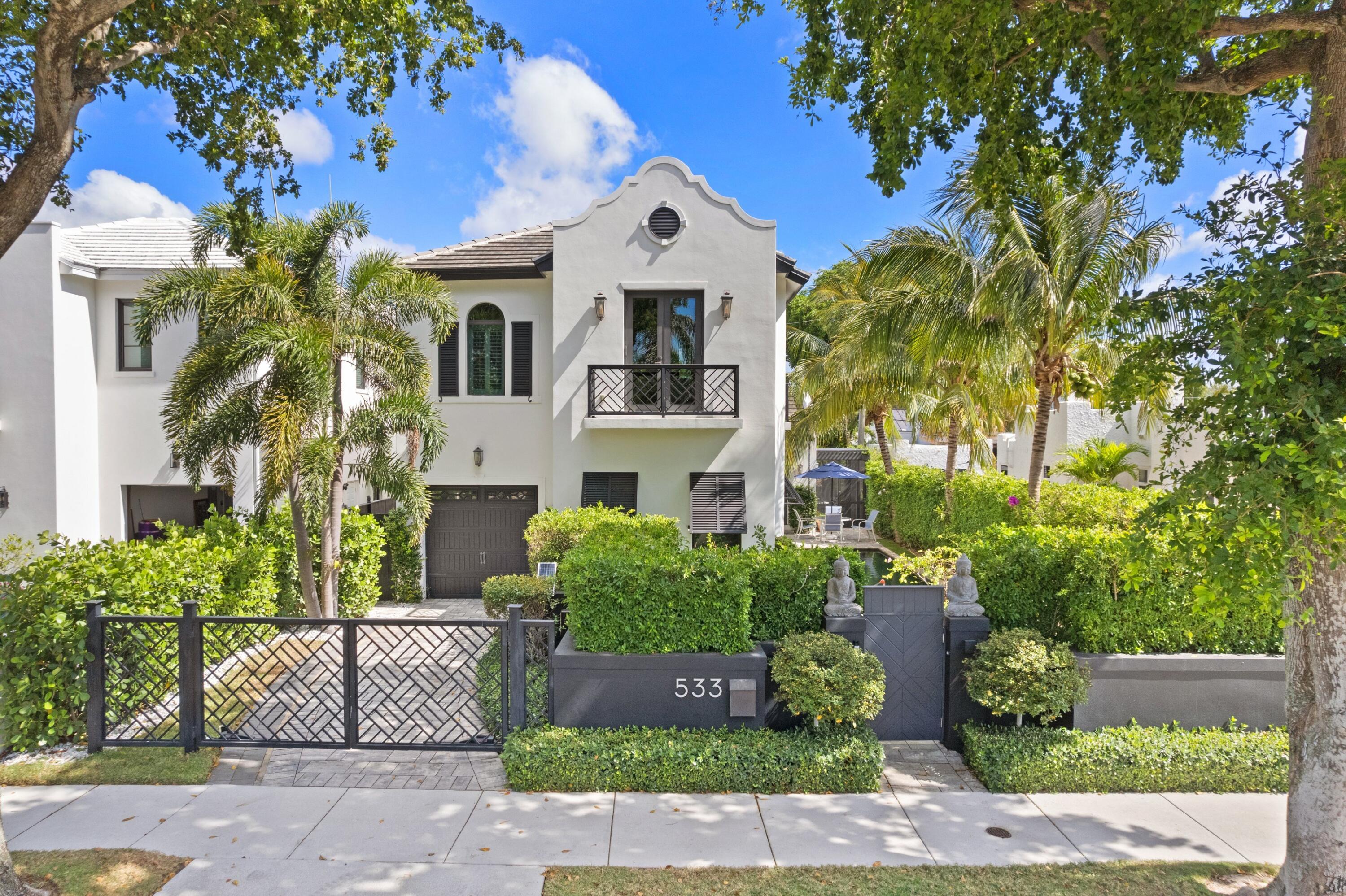 533 Westwood Road West Palm Beach, FL 33401 - Photo 1 of 43 a front view of a house with a garden