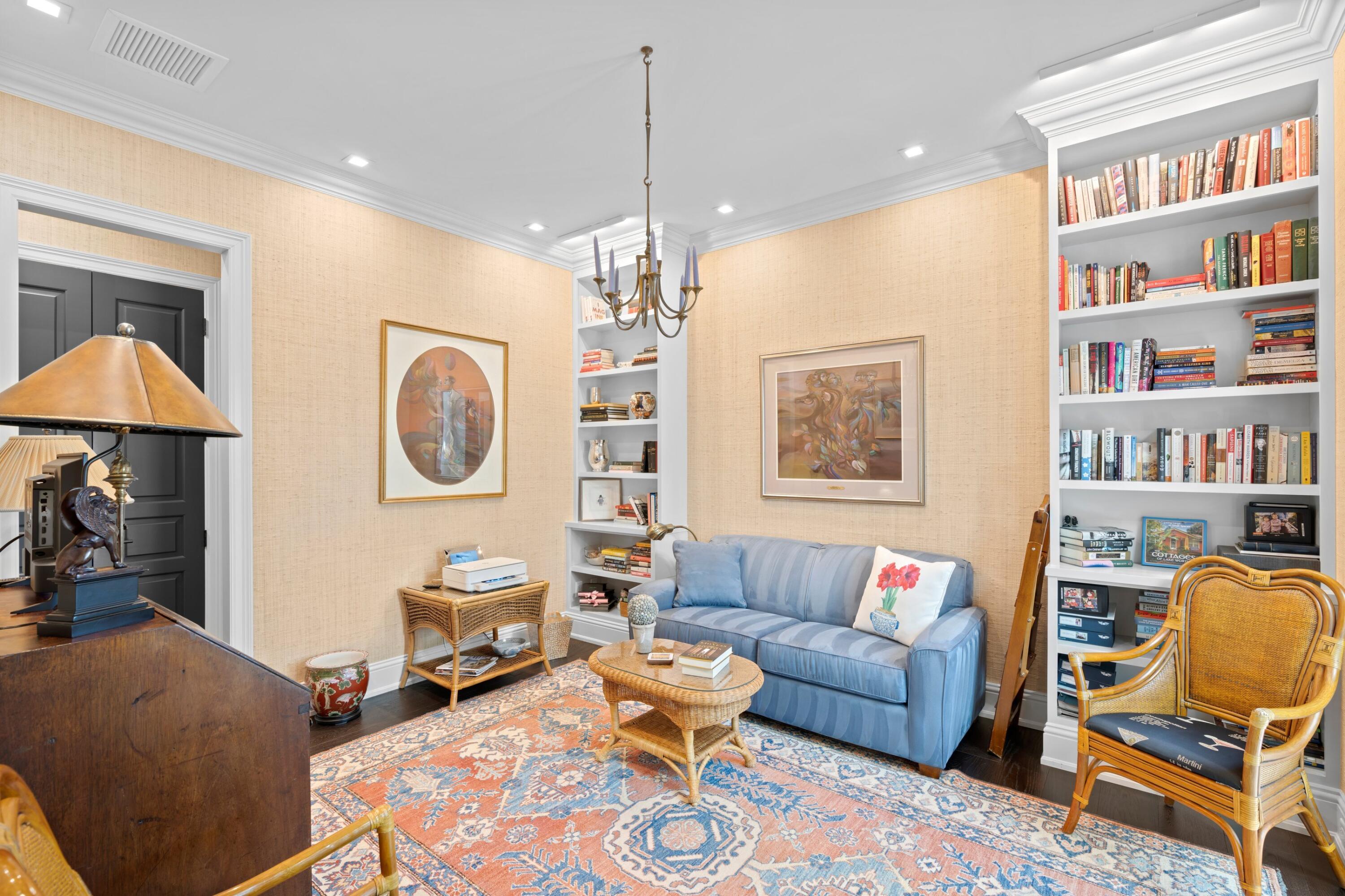 533 Westwood Road West Palm Beach, FL 33401 - Photo 17 of 43 a living room with furniture a chandelier and a bookshelf