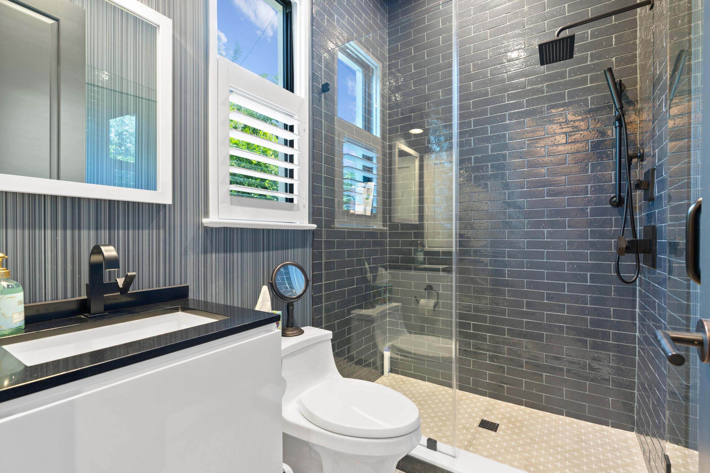 533 Westwood Road West Palm Beach, FL 33401 - Photo 19 of 43 a bathroom with a toilet a sink and shower