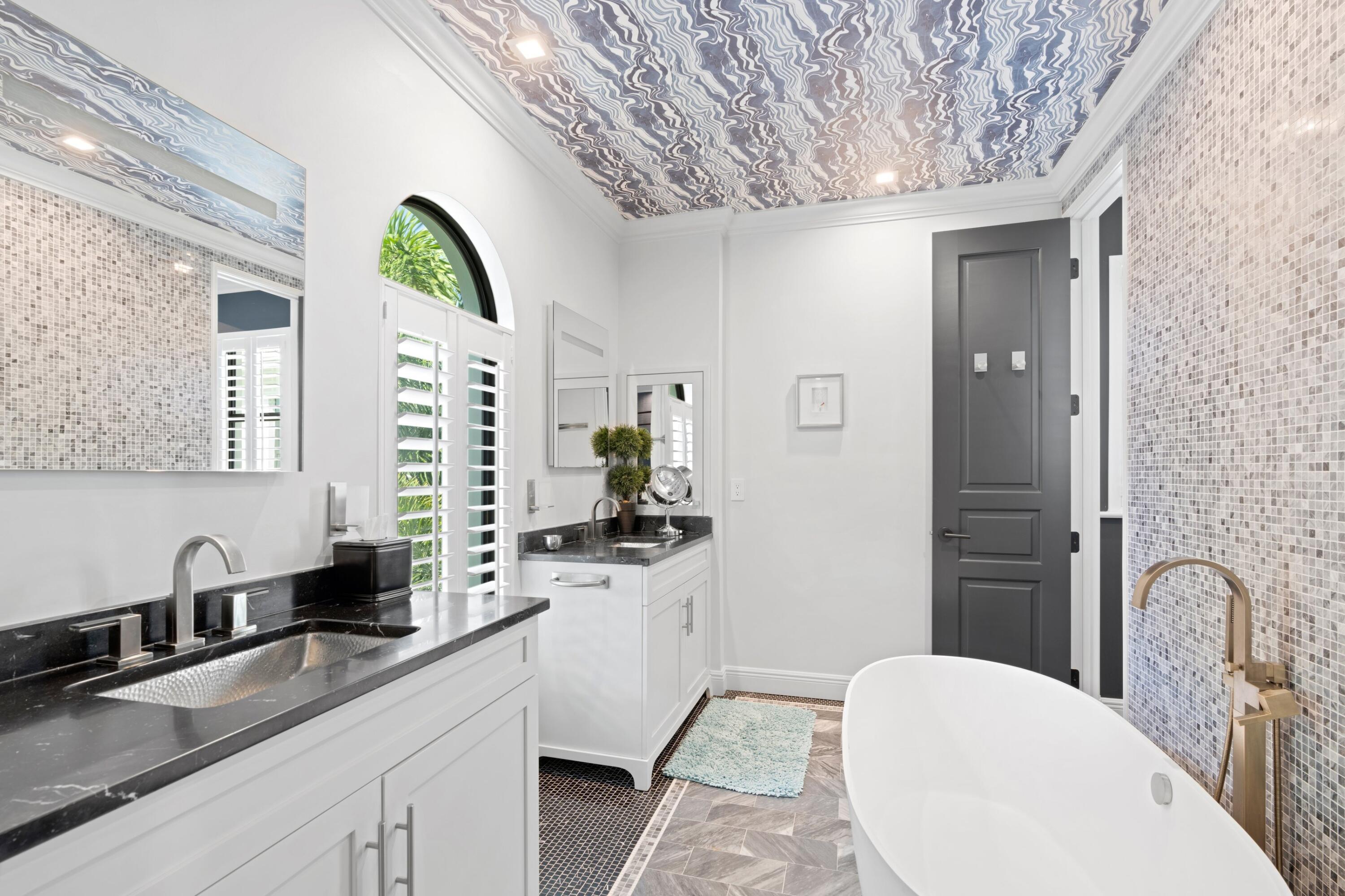 533 Westwood Road West Palm Beach, FL 33401 - Photo 24 of 43 a spacious bathroom with a granite countertop sink mirror and vanity