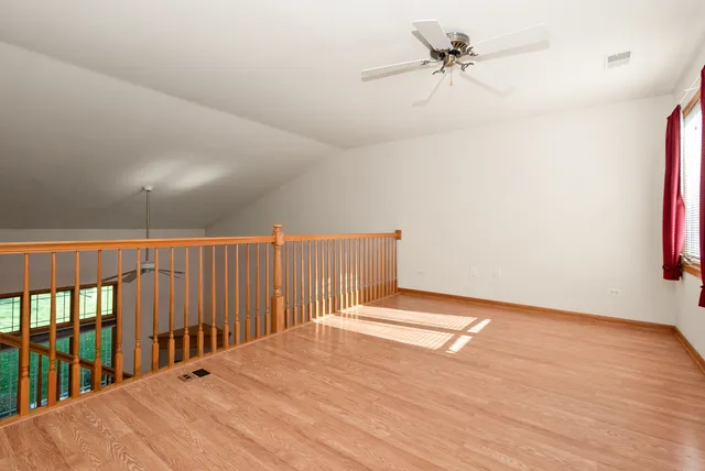 a view of a room with wooden floor