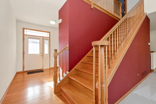 a view of entryway and hall with wooden floor