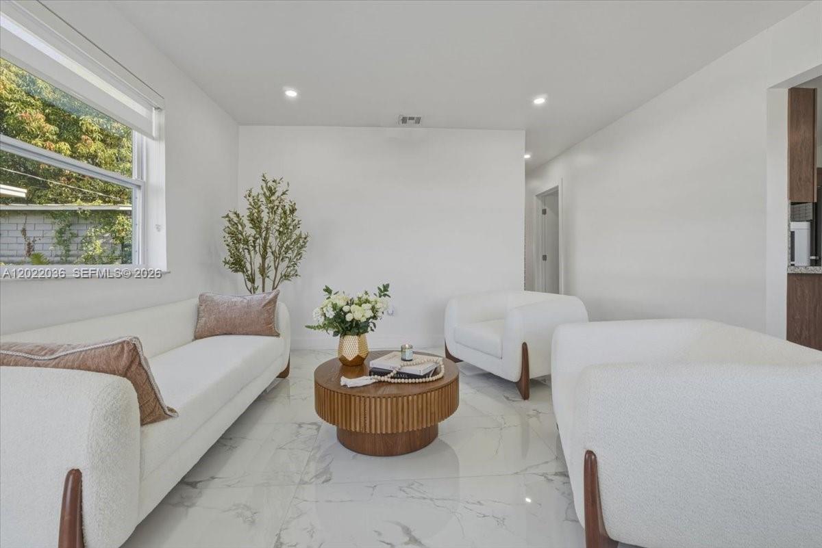 120 West 50th Street Hialeah, FL 33012 - Photo 6 of 22 a living room with furniture and a large window