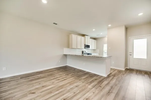 a view of an empty room with a ceiling fan