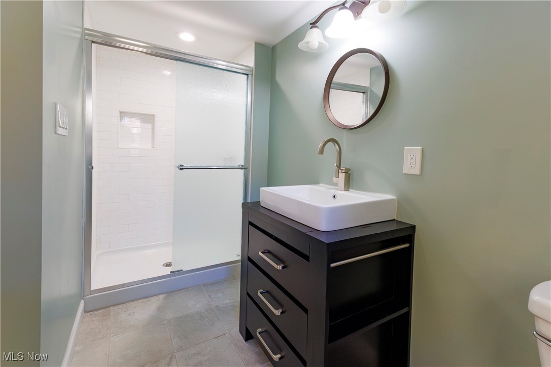 36625 Jackson Road Chagrin Falls, OH 44022 - Photo 31 of 50 Bathroom featuring vanity, toilet, and an enclosed shower