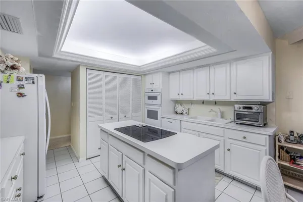 a kitchen with a sink a stove a refrigerator and cabinets