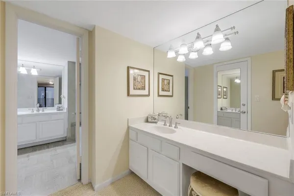 a bathroom with a sink mirror and vanity