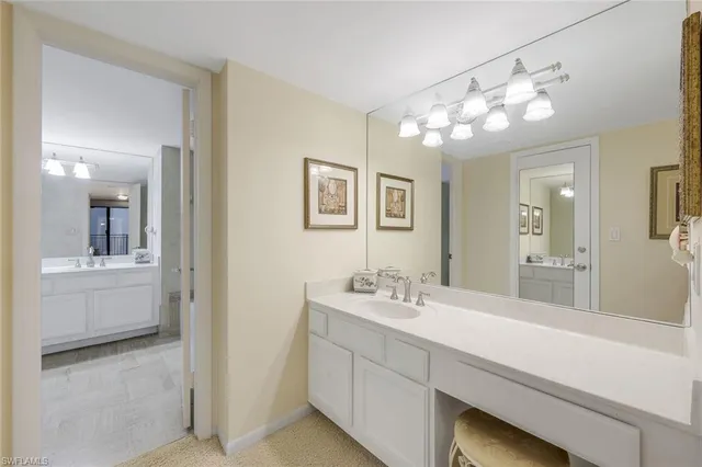 a bathroom with a sink mirror and vanity