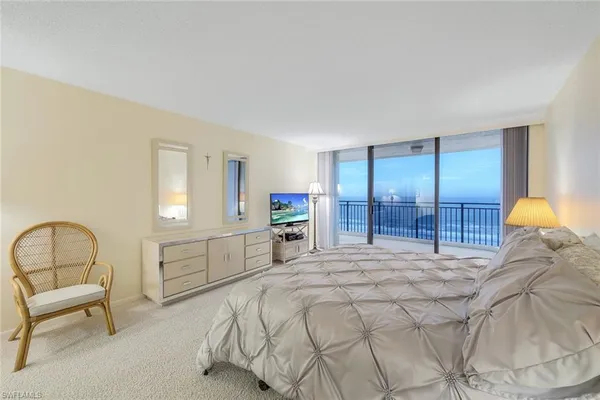 a bedroom with a bed and a chair