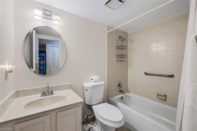 a bathroom with a toilet a sink a mirror and bathtub