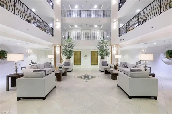 a living room with fireplace furniture and a chandelier
