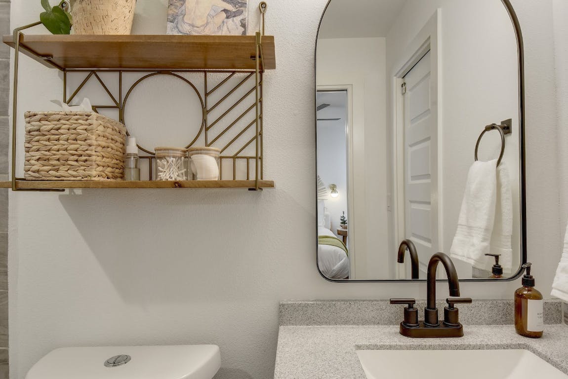 2901 Glen Rae Street, Unit A Austin, TX 78702 - Photo 21 of 36 a bathroom with a sink a toilet and a mirror