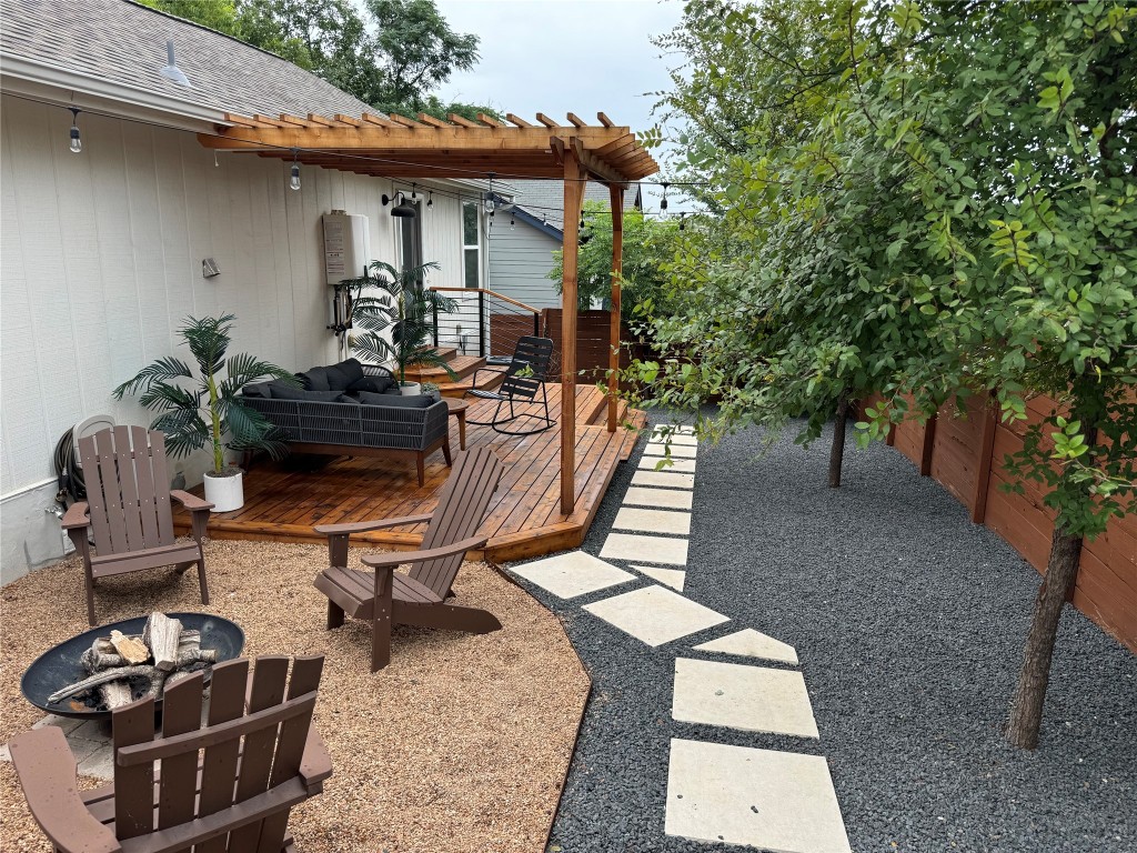 2901 Glen Rae Street, Unit A Austin, TX 78702 - Photo 32 of 36 a view of a patio with table and chairs potted plants and a large tree
