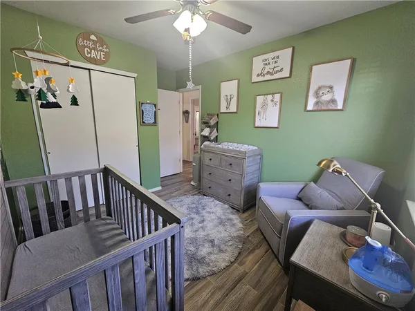 a living room with furniture a desk and chair with wooden floor