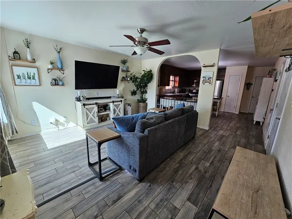 a kitchen with stainless steel appliances granite countertop a stove refrigerator and chairs