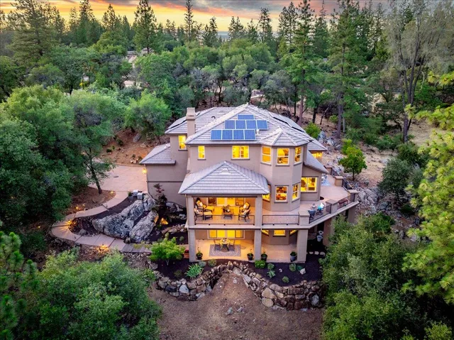 an aerial view of a house with swimming pool and garden space