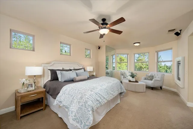a view of a house with large windows and a table and chairs