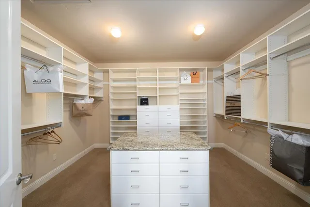 a front view of a house with a yard and tree s