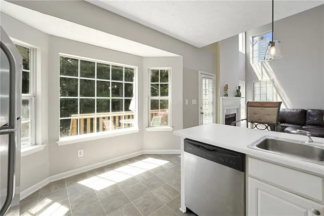 a room with a window and a kitchen