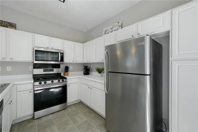 a white refrigerator freezer and a stove top oven