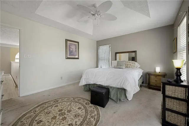 a spacious bedroom with a bed and a couch