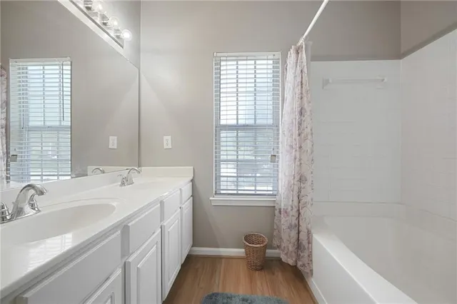 a bathroom with a granite countertop sink a toilet and bathtub