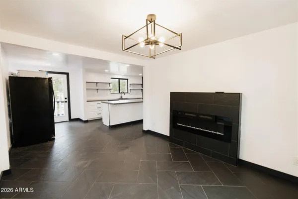 a white house that has a tree in front of it